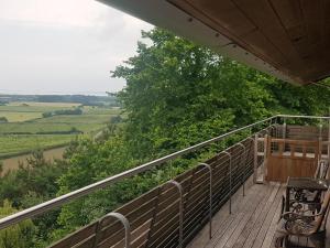 a balcony with chairs and a view of the countryside at Powis Cottage in Laugharne