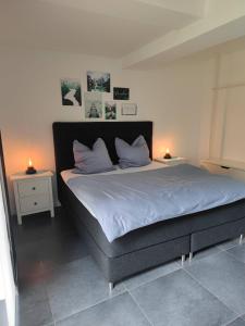 a bedroom with a large bed with two night stands at Moers City Apartments in Moers