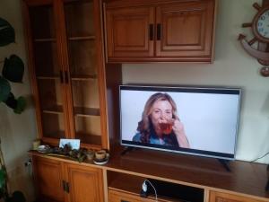 a flat screen tv sitting on top of a counter at Casa de verano in O Grove