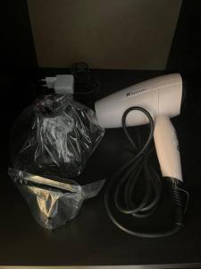 a hair dryer and a plastic bag on a table at Studio im Herzen von Monte Carlo in Monte Carlo