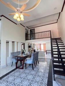 a dining room and living room with a ceiling fan at Dao Residence Boutique Apartment 