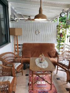 a patio with a couch and chairs and a table at Shtepia e luleve in Golem