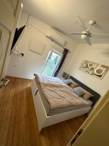 a small bedroom with a bed and a window at Holiday house Ina*** in Barbat na Rabu