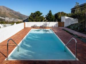 a swimming pool in the backyard of a house at Umoya Boutique Hotel & Villas in Cape Town