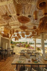 a restaurant with tables and chairs and chandeliers at Green Life Apartments Sozopol in Sozopol