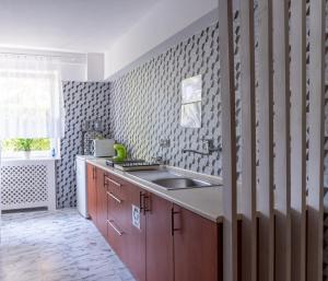 a kitchen with a sink and a counter top at Piast in Karwia +176 photos