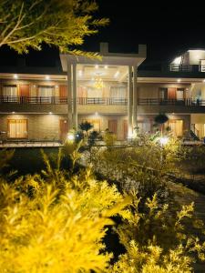 a building with a lot of plants in front of it at Vasant Corbett Resort in Rāmnagar