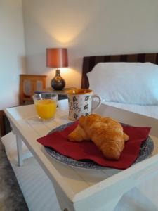 a table with a plate of food and a cup of orange juice at Vavasour in York