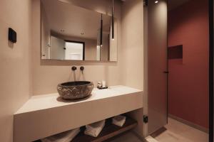 a bathroom with a sink and a mirror at Ikyma Boutique in Polykhrono