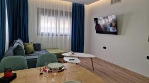 a living room with a couch and a table at Magdalena Suite 4.0 in Heraklio Town