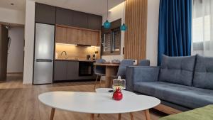 a living room with a couch and a table at Magdalena Suite 4.0 in Heraklio Town