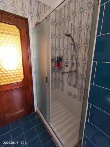 a shower with a glass door in a bathroom at Room in Apartment - La Palma King Room With Balcony in Cagliari