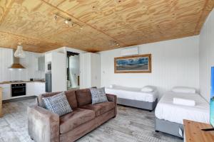 a living room with a couch and a bed at Kahala in Point Lookout