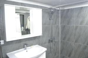 a bathroom with a shower and a sink and a mirror at Family & Relax Loft Lake House in Zagalʼtsy +50 photos