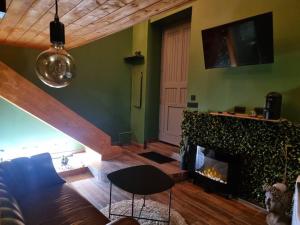 a living room with a fireplace and a stairway at Tropic Love Room in Lyon
