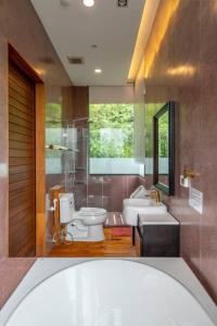ein Badezimmer mit einer Badewanne, einem WC und einem Waschbecken in der Unterkunft Suite R4-5 The Height Khaoyai 2BR byน้องมังคุด in Ban Huai Sok Noi