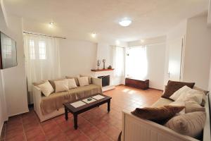 a living room with a couch and a coffee table at Orestis Mansion Skiathos in Skiathos