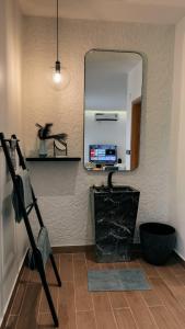 a bathroom with a mirror and a shelf and a sink at شاليه الجبل in Ḑubā