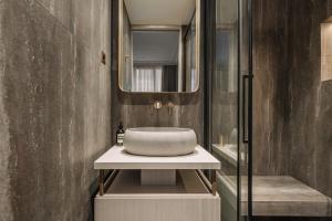 a bathroom with a sink and a mirror at HIGHSTAY - Luxury Serviced Apartments - Centre Pompidou Museum in Paris