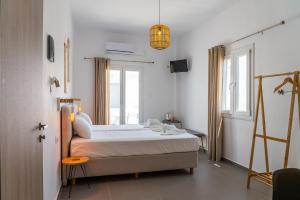 a bedroom with a bed and a window at Eleftheria Studios in Antiparos