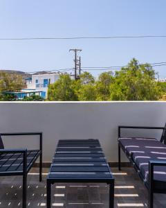 two benches sitting on top of a roof at Eleftheria Studios in Antiparos