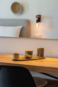 a wooden table with two logs on top of it at Eleftheria Studios in Antiparos