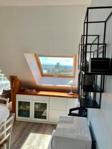 a room with a window and a table with a chair at Grand appartement lumineux 4 pers. / vue mer / Wifi inclus in Quiberon