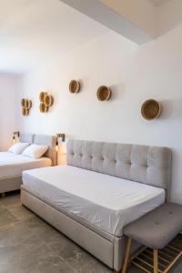 a bedroom with a bed and a chair at Eleftheria Studios in Antiparos