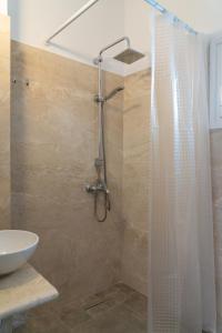 a shower with a shower curtain in a bathroom at Eleftheria Studios in Antiparos