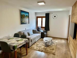 a living room with a couch and a table at D'Hérens apartment in Breuil-Cervinia