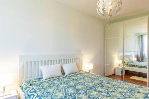 a bedroom with a large bed and a mirror at Danube View Apartment - Bodor utca in Budapest