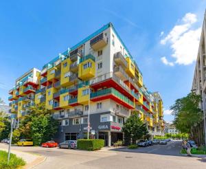 a large apartment building with colorful balconies on a street at Danube View Apartment - Bodor utca in Budapest
