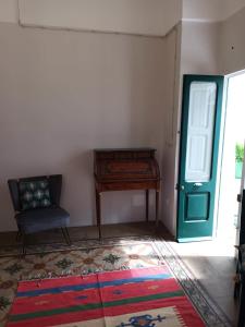 une chambre avec un piano et une chaise à côté d'une porte dans l'établissement Room in BB - Casa Dulcamara centro storico, à Salve