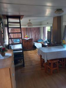 a room with two bunk beds and a kitchen with a table at Stara Kuźnia in Sosnówka