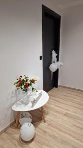 a room with a table with a vase of flowers on it at Magdalena Suite 4.0 in Heraklio Town +14 photos