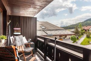 a balcony with a chair and a view of a building at Haus Excelsior Top 31 in Seefeld in Tirol