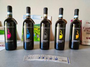 a group of four bottles of wine sitting on a table at Cascina BELLONUOVO in Alba +62 photos