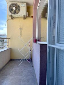 a balcony with a heater and a fan at Апартамент Чаролит / Apartment Charoite in Burgas City