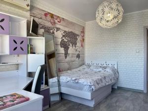 a bedroom with a bed with a map on the wall at Апартамент Чаролит / Apartment Charoite in Burgas City