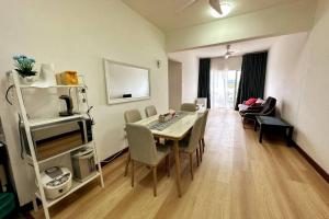 a living room with a table and chairs in a room at Green-Scenery Suburban by Irdina's Homestay in Kampong Perimbun