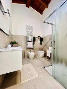 a bathroom with a shower and a sink and a toilet at La Rocchetta B&B in Guiglia +32 photos