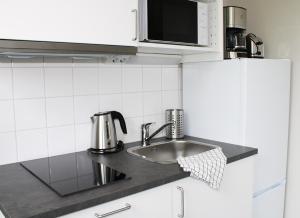 uma cozinha com um lavatório e um micro-ondas em Sidsjö Hotell & Konferens em Sundsvall