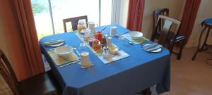 a blue table with plates and dishes on it at Wharfe View B&B in Burnsall