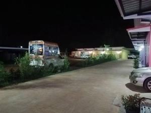 an old truck parked in a parking lot at night at JUNPEN RESORT in Ban Hai Yong