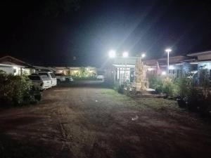 a parking lot at night with lights on at JUNPEN RESORT in Ban Hai Yong