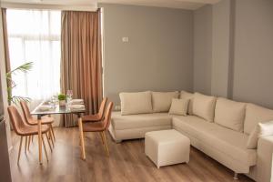 a living room with a couch and a table at Wave Beachfront Apartments in Durrës