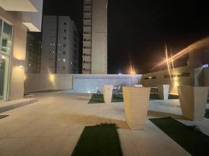 a view of a courtyard at night with buildings at White Luxury Suite Hotel in Kuwait