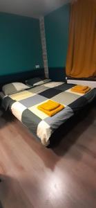 a bed in a room with yellow towels on it at joni, not a hotel, not for parties in Amsterdam