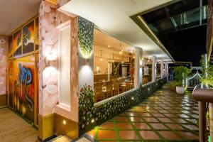 a lobby of a restaurant with plants on the walls at Star Emirates Luxury Resort and Spa, Munnar in Anachal