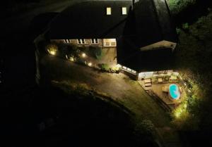 an aerial view of a house at night with lights at Woodpecker Cottage in Blakeney